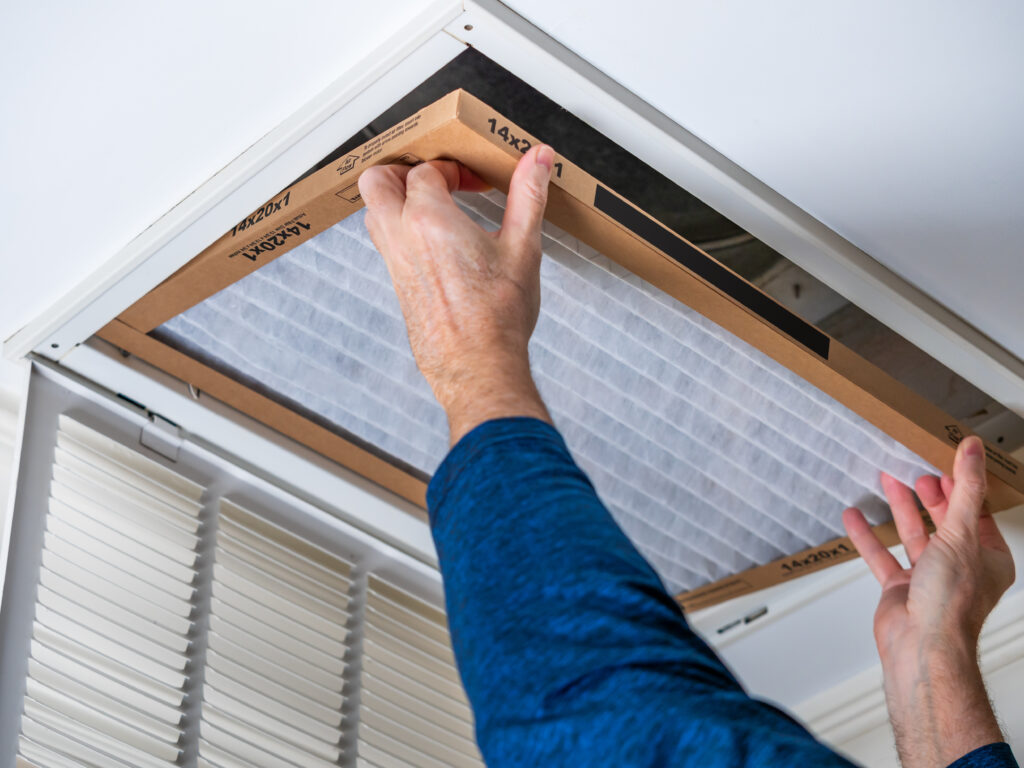 HVAC technician replacing a home air filter in Lomita