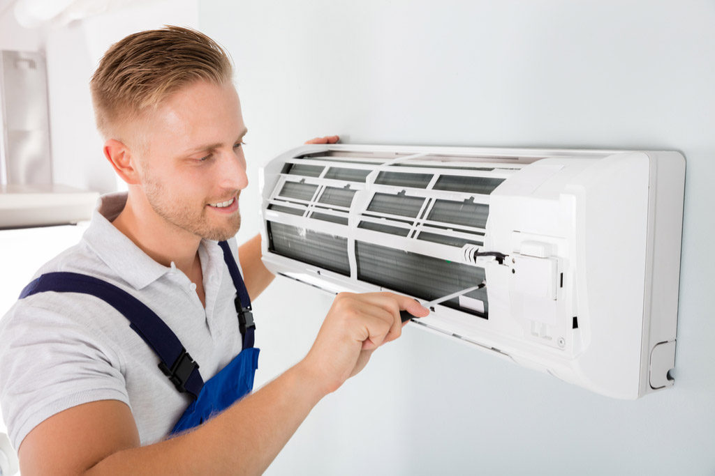 HVAC technician maintaining a ductless air conditioner in Lomita
