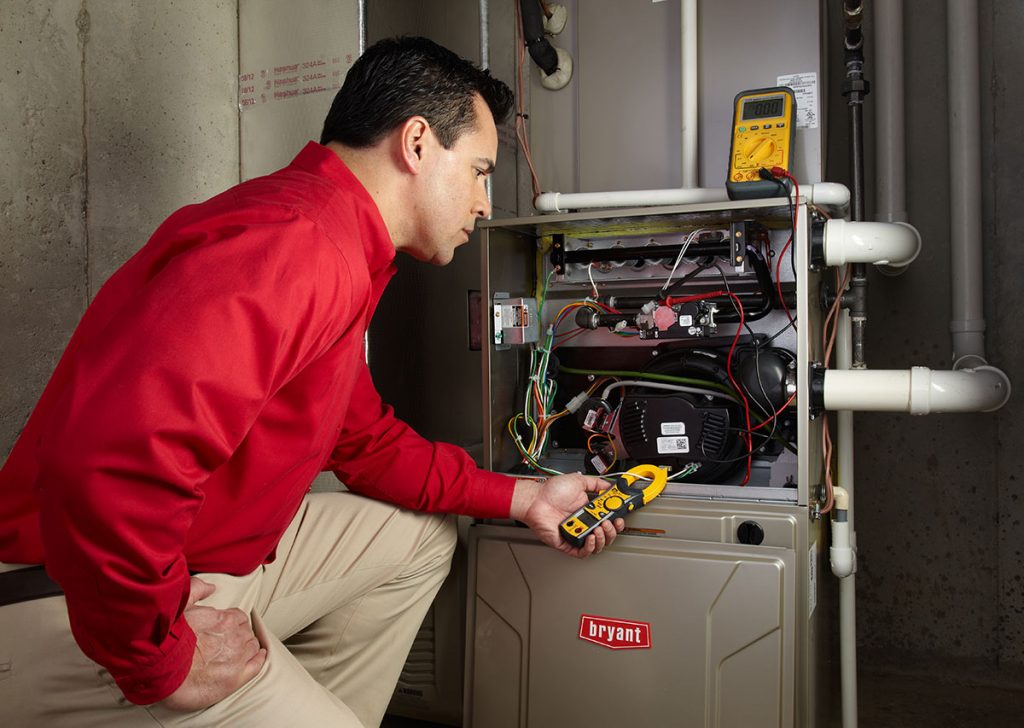 Heating technician diagnosing a furnace repair in Lomita