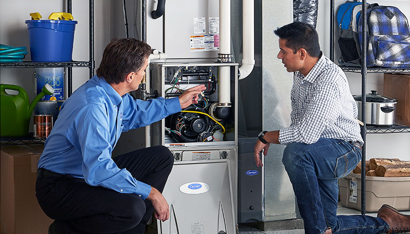 Technician evaluating a furnace for repair or replacement in Lomita