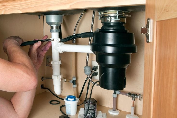 Plumber repairing a garbage disposal in Lomita
