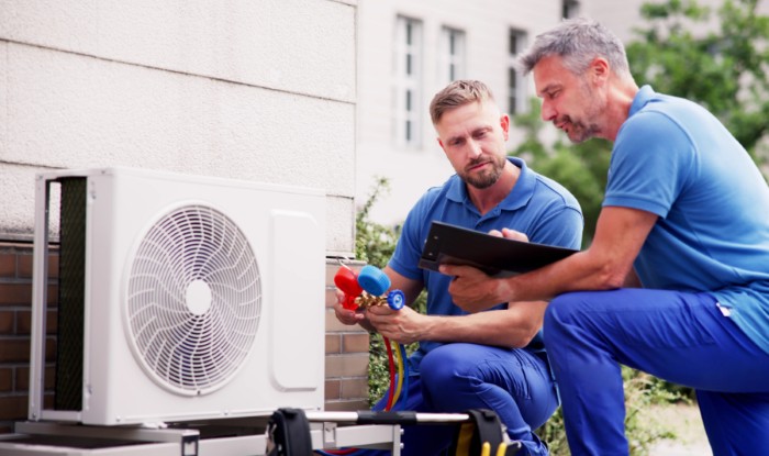 HVAC technicians installing an outdoor air conditioning unit in Lomita