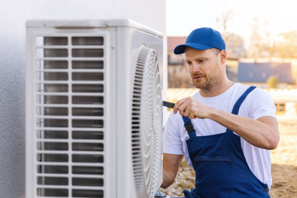 HVAC technician servicing an outdoor air conditioner in Lomita