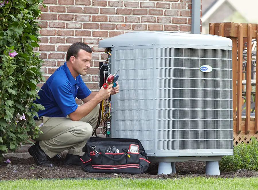 HVAC technician inspecting an outdoor AC unit in Lomita